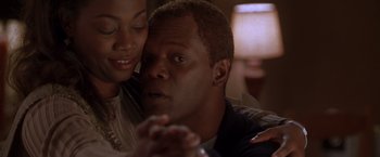 Movie still from “The Negotiator” (1998), directed by F. Gary Gray – A man and a woman holding hands in a dark room; Close Up shot, Low angle