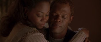 Movie still from “The Negotiator” (1998), directed by F. Gary Gray – A person and a woman with their eyes closed; Close Up shot, Low angle