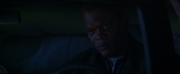 Movie still from “The Negotiator” (1998), directed by F. Gary Gray – A person sitting in a car in the dark; Close Up shot, Over the shoulder angle