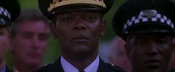 Movie still from “The Negotiator” (1998), directed by F. Gary Gray – A person wearing a uniform; Close Up shot, Low angle