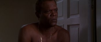 Movie still from “The Negotiator” (1998), directed by F. Gary Gray – A person wearing a necklace; Close Up shot, High angle