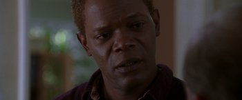 Movie still from “The Negotiator” (1998), directed by F. Gary Gray – A man's face in a brown shirt; Close Up shot, High angle
