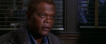 Movie still from “The Negotiator” (1998), directed by F. Gary Gray – A person wearing a shirt and jacket; Close Up shot, High angle