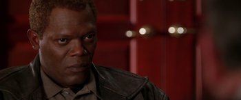 Movie still from “The Negotiator” (1998), directed by F. Gary Gray – A person wearing a leather jacket; Close Up shot, Over the shoulder angle