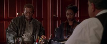 Movie still from “The Negotiator” (1998), directed by F. Gary Gray – A man and a woman sitting at a table; Medium shot, Over the shoulder angle