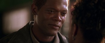 Movie still from “The Negotiator” (1998), directed by F. Gary Gray – A man's face in a dark room; Close Up shot, Over the shoulder angle