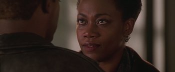 Movie still from “The Negotiator” (1998), directed by F. Gary Gray – A person looking at the camera; Close Up shot, Over the shoulder angle