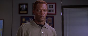 Movie still from “The Negotiator” (1998), directed by F. Gary Gray – A person standing in a room; Close Up shot, High angle