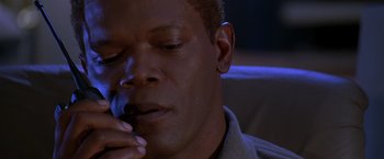 Movie still from “The Negotiator” (1998), directed by F. Gary Gray – A person holding his hand to his face; Close Up shot, High angle