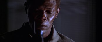 Movie still from “The Negotiator” (1998), directed by F. Gary Gray – A person with a spray paint on his face; Close Up shot, Low angle