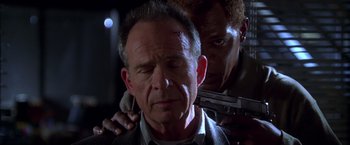 Movie still from “The Negotiator” (1998), directed by F. Gary Gray – A man with a gun and another man holding a gun; Close Up shot, Low angle
