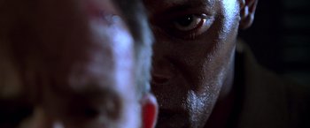 Movie still from “The Negotiator” (1998), directed by F. Gary Gray – A man's face with a knife in his hand; Extreme Close Up shot, Low angle