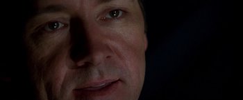Movie still from “The Negotiator” (1998), directed by F. Gary Gray – A man's face in the dark; Extreme Close Up shot, Low angle