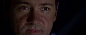 Movie still from “The Negotiator” (1998), directed by F. Gary Gray – A man's eyes with a dark background; Extreme Close Up shot, Low angle