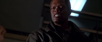 Movie still from “The Negotiator” (1998), directed by F. Gary Gray – A person wearing a leather jacket; Close Up shot, Low angle