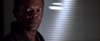 Movie still from “The Negotiator” (1998), directed by F. Gary Gray – A man's face in front of blinds; Close Up shot, Low angle