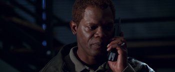 Movie still from “The Negotiator” (1998), directed by F. Gary Gray – A person talking on a cell phone; Close Up shot, High angle