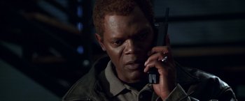 Movie still from “The Negotiator” (1998), directed by F. Gary Gray – A person talking on a cell phone; Close Up shot, High angle