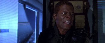 Movie still from “The Negotiator” (1998), directed by F. Gary Gray – A person wearing a black jacket; Close Up shot, Low angle