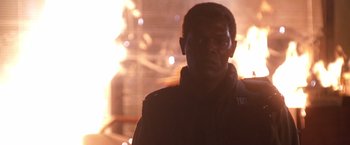 Movie still from “The Negotiator” (1998), directed by F. Gary Gray – A person wearing glasses and a jacket; Close Up shot, Low angle