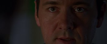 Movie still from “The Negotiator” (1998), directed by F. Gary Gray – A man's eyes and face; Extreme Close Up shot, Low angle