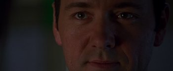 Movie still from “The Negotiator” (1998), directed by F. Gary Gray – A man's face in the dark; Extreme Close Up shot, Low angle