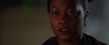 Movie still from “The Negotiator” (1998), directed by F. Gary Gray – A woman's face in the dark; Close Up shot, Low angle