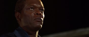 Movie still from “The Negotiator” (1998), directed by F. Gary Gray – A man's face in the dark; Close Up shot, Low angle