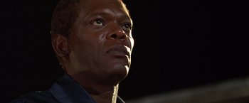 Movie still from “The Negotiator” (1998), directed by F. Gary Gray – A man's face looking upward; Close Up shot, Low angle