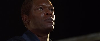 Movie still from “The Negotiator” (1998), directed by F. Gary Gray – A man's face looking upward; Close Up shot, Low angle