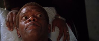 Movie still from “The Negotiator” (1998), directed by F. Gary Gray – A person laying on a bed; Close Up shot, High angle