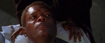 Movie still from “The Negotiator” (1998), directed by F. Gary Gray – A person laying on a bed; Close Up shot, Low angle