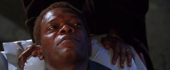 Movie still from “The Negotiator” (1998), directed by F. Gary Gray – A person laying on a bed; Close Up shot, Low angle