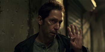 Movie still from “Guillermo del Toro's Cabinet of Curiosities” (2022), directed by Keith Thomas – A person holding his hand up; Close Up shot, Over the shoulder angle