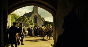 Movie still from “The Other Boleyn Girl” (2008), directed by Justin Chadwick – A group of people standing in front of a building; Extreme Wide shot, Low angle