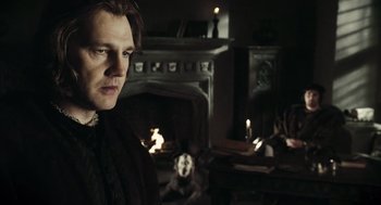 Movie still from “The Other Boleyn Girl” (2008), directed by Justin Chadwick – A man standing in front of a fire place; Medium shot, Over the shoulder angle