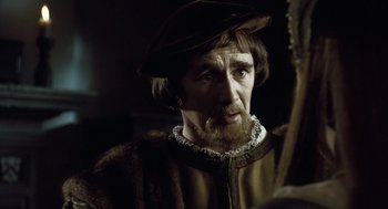 Movie still from “The Other Boleyn Girl” (2008), directed by Justin Chadwick – A man with a beard and a hat on; Close Up shot, Over the shoulder angle