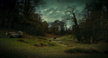 Movie still from “The Other Boleyn Girl” (2008), directed by Justin Chadwick – A cow is standing in a field near a forest; Extreme Wide shot, High angle