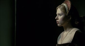 Movie still from “The Other Boleyn Girl” (2008), directed by Justin Chadwick – A young woman in a black dress looking to the side; Close Up shot, Low angle