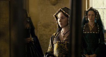 Movie still from “The Other Boleyn Girl” (2008), directed by Justin Chadwick – A young woman in a medieval dress looking into the distance; Medium shot, Over the shoulder angle