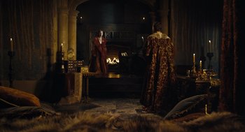 Movie still from “The Other Boleyn Girl” (2008), directed by Justin Chadwick – Two men in medieval garb standing in front of a fireplace; Wide shot, Over the shoulder angle
