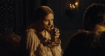Movie still from “The Other Boleyn Girl” (2008), directed by Justin Chadwick – A young woman holding a glass of wine in her hand; Close Up shot, Over the shoulder angle