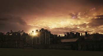 Movie still from “The Other Boleyn Girl” (2008), directed by Justin Chadwick – The sun is setting behind a castle like building; Extreme Wide shot, Low angle