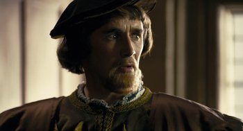 Movie still from “The Other Boleyn Girl” (2008), directed by Justin Chadwick – A person with a beard and a hat; Close Up shot, Over the shoulder angle