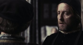 Movie still from “The Other Boleyn Girl” (2008), directed by Justin Chadwick – A man wearing a black hat looking at another man in a black hat; Close Up shot, Over the shoulder angle