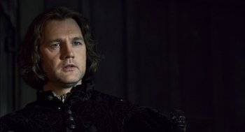 Movie still from “The Other Boleyn Girl” (2008), directed by Justin Chadwick – A person wearing a suit and tie; Close Up shot, Over the shoulder angle