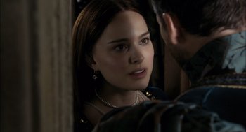 Movie still from “The Other Boleyn Girl” (2008), directed by Justin Chadwick – A young woman wearing a pearl necklace looking at a man; Close Up shot, Over the shoulder angle