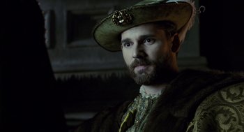 Movie still from “The Other Boleyn Girl” (2008), directed by Justin Chadwick – A man with a beard wearing a green hat; Close Up shot, Over the shoulder angle