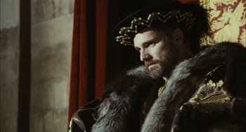 Movie still from “The Other Boleyn Girl” (2008), directed by Justin Chadwick – A bearded man wearing a fur coat and a crown; Close Up shot, Over the shoulder angle