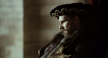 Movie still from “The Other Boleyn Girl” (2008), directed by Justin Chadwick – A man wearing a fur coat and a crown; Close Up shot, Over the shoulder angle